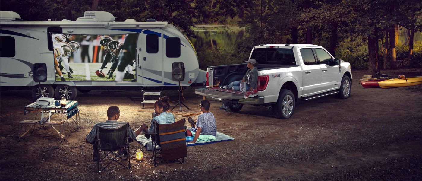 2024 Ford F-150 exterior campsite with family watching football on projection