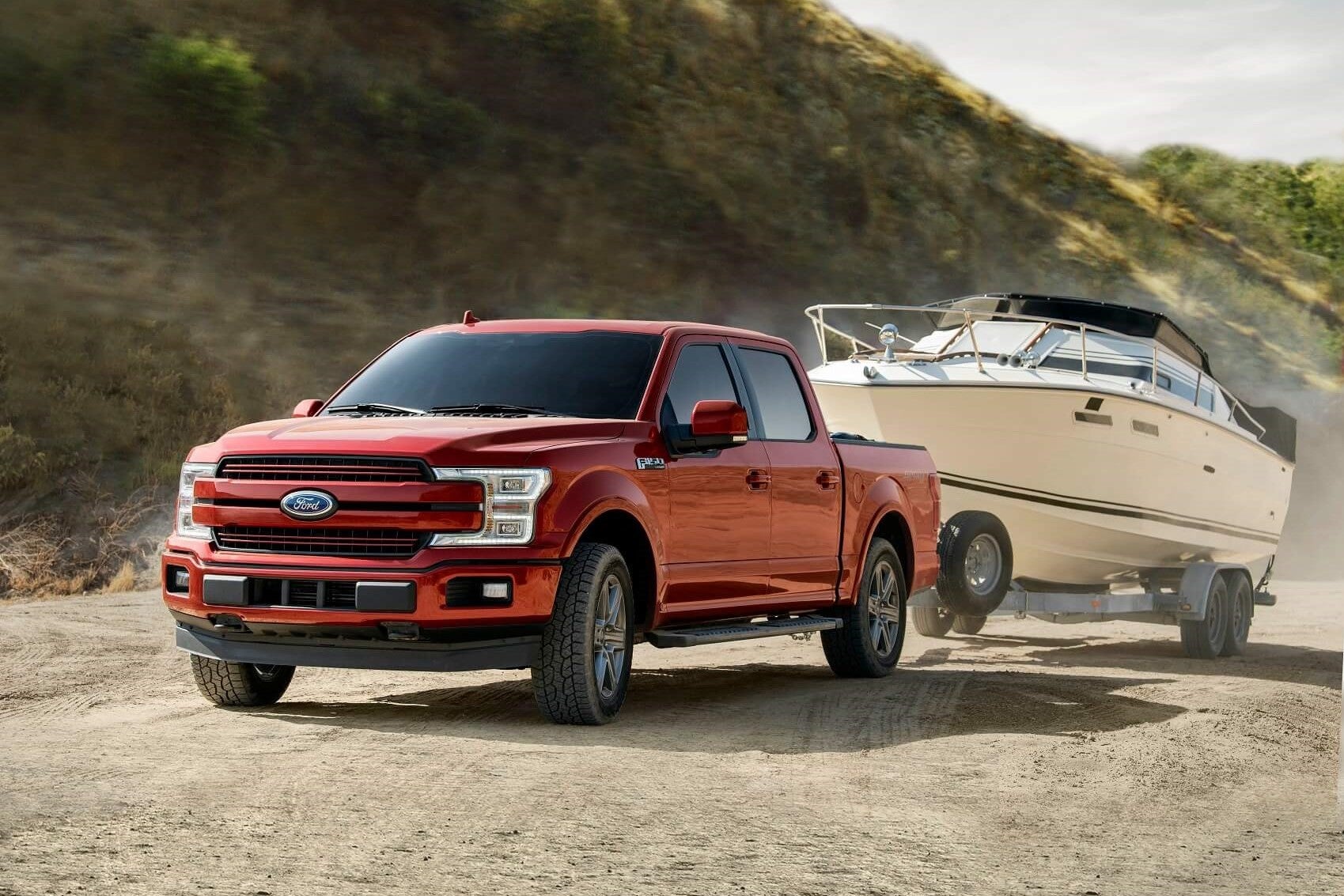 With a towing capacity of 14,000 pounds, a red Ford F-150 easily tows a boat
