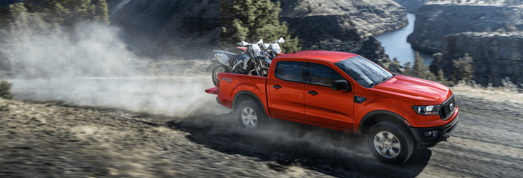 Red Ford Ranger's payload capacity allows it to carry several motorbikes in the bed