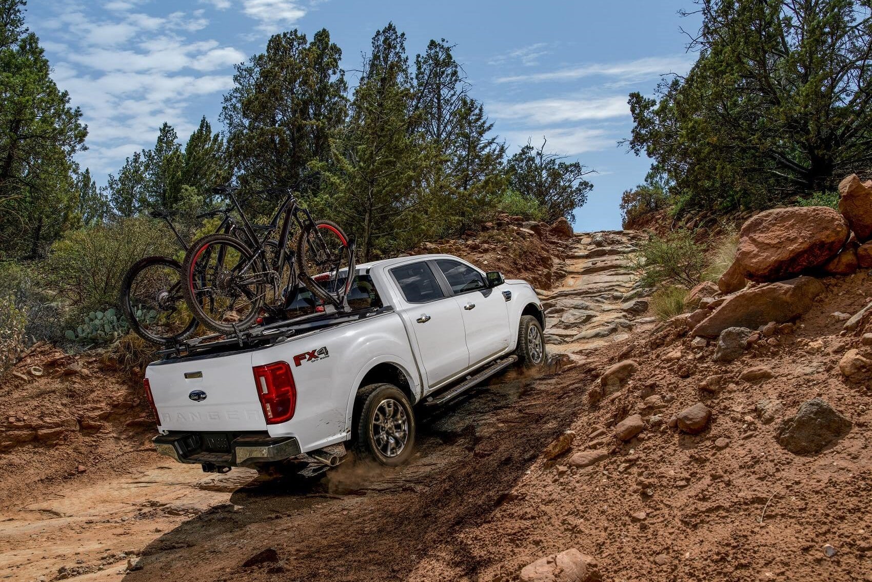 Ford Ranger stores bikes in the bed while driving off-road in the mud