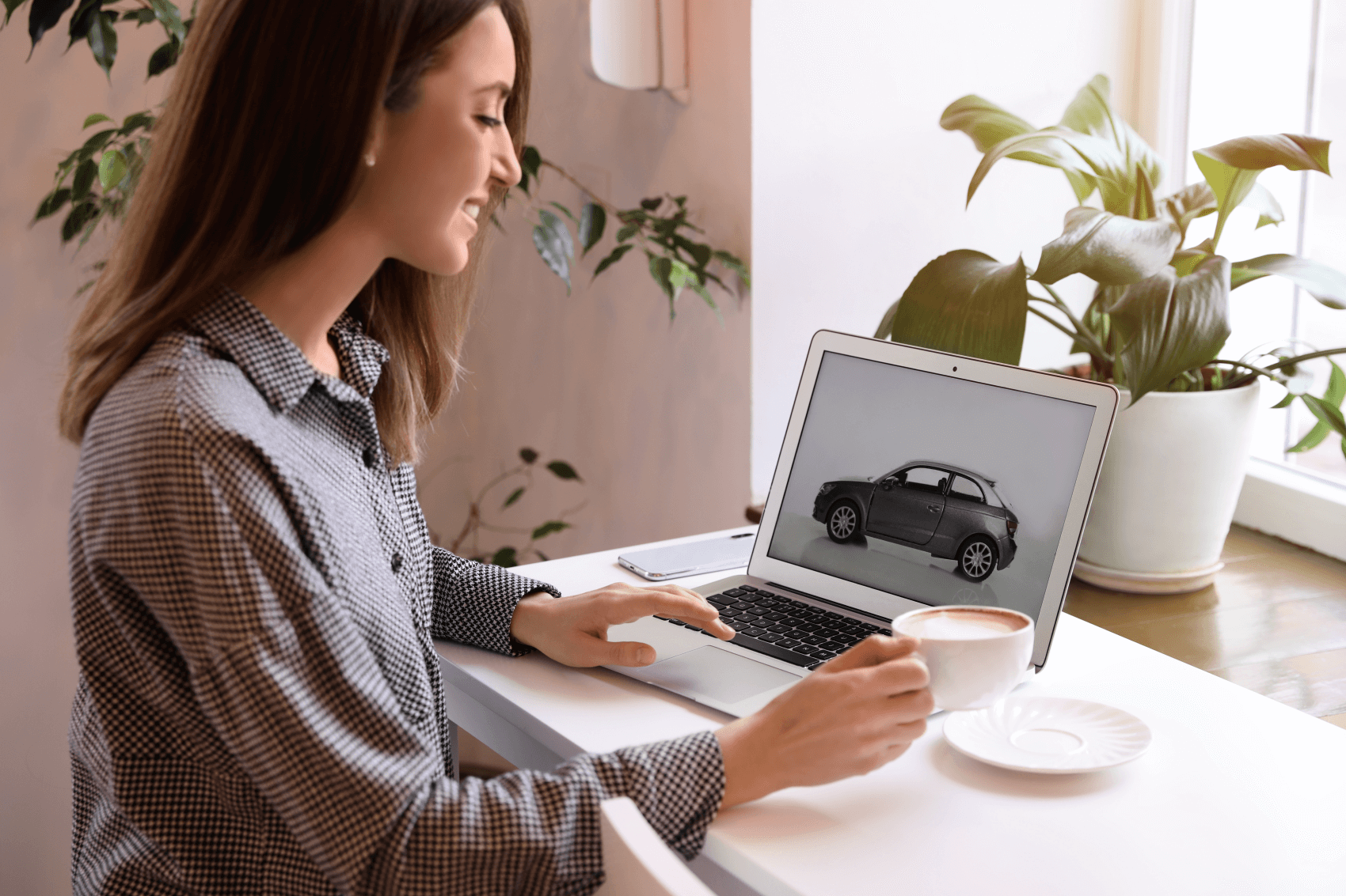 Woman smiling while browsing cars at home, from Feldman Ford of Detroit